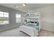 Bright bedroom featuring a white bunk bed with a desk and two windows that let in natural light at 540 Teversham Dr, Mcdonough, GA 30253