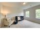 Charming Bedroom with natural lighting from two windows, a crib, and a cozy armchair at 540 Teversham Dr, Mcdonough, GA 30253