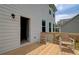 Inviting wooden deck with seating area and open door, perfect for relaxing at 540 Teversham Dr, Mcdonough, GA 30253