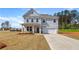 Charming two-story home featuring a covered front porch and an attached two-car garage at 540 Teversham Dr, Mcdonough, GA 30253