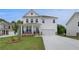 Inviting two-story home featuring a covered front porch, two-car garage, and a green lawn at 540 Teversham Dr, Mcdonough, GA 30253