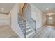 Inviting hallway with wood floors, a staircase, and views into the kitchen and entryway at 540 Teversham Dr, Mcdonough, GA 30253