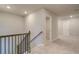 Second floor hallway featuring carpet and railing, with doors leading to other rooms at 540 Teversham Dr, Mcdonough, GA 30253
