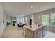 Open concept kitchen island with view to the living room and dining area at 540 Teversham Dr, Mcdonough, GA 30253