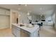Spacious kitchen island featuring stainless steel appliances, quartz countertops, and open concept living at 540 Teversham Dr, Mcdonough, GA 30253