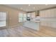 Stylish kitchen featuring white cabinetry, stainless steel appliances, and a center island at 540 Teversham Dr, Mcdonough, GA 30253