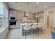 Bright kitchen featuring stainless steel appliances, gray cabinets, a kitchen island, and quartz countertops at 540 Teversham Dr, Mcdonough, GA 30253