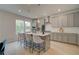 Modern kitchen with gray cabinets, quartz countertops, stainless steel appliances and island seating at 540 Teversham Dr, Mcdonough, GA 30253