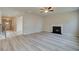 Open-concept living room with wood floors, a fireplace, and ample natural light at 540 Teversham Dr, Mcdonough, GA 30253