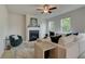 Comfortable living room featuring a fireplace, ceiling fan, and plush seating at 540 Teversham Dr, Mcdonough, GA 30253