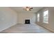 Comfortable living room featuring wood floors, large windows, and a cozy fireplace at 540 Teversham Dr, Mcdonough, GA 30253