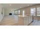 Open-concept living room featuring hardwood floors, a fireplace, and ample natural light from large windows at 540 Teversham Dr, Mcdonough, GA 30253