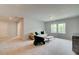 Open living room area with neutral colors, soft carpet, and plenty of natural light through large windows at 540 Teversham Dr, Mcdonough, GA 30253