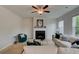 Inviting living room with fireplace, ceiling fan, and cozy furnishings at 540 Teversham Dr, Mcdonough, GA 30253