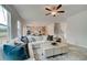 Spacious living room with a comfortable white sofa, ceiling fan and open floor plan at 540 Teversham Dr, Mcdonough, GA 30253