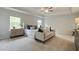 Serene main bedroom with tray ceiling, neutral palette, plush carpeting, and large windows for ample light at 540 Teversham Dr, Mcdonough, GA 30253