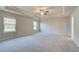 Expansive primary bedroom with trey ceiling, plush carpet, and large windows, with an ensuite at 540 Teversham Dr, Mcdonough, GA 30253