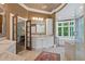 Bright bathroom with double vanity, soaking tub, and walk-in shower with natural light and elegant finishes at 960 Tiverton Ln, Alpharetta, GA 30022
