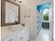 Modern bathroom with a pedestal sink, arched ceilings, natural light, and separate toilet area at 960 Tiverton Ln, Alpharetta, GA 30022