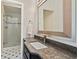 Modern bathroom with a marble countertop, vanity, frameless glass shower, and stylish tiling at 960 Tiverton Ln, Alpharetta, GA 30022