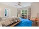 Bright bedroom with a ceiling fan, hardwood floors, ample natural light, and a large window view at 960 Tiverton Ln, Alpharetta, GA 30022