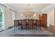Traditional dining room featuring an ornate rug, large window, and modern lighting fixture at 960 Tiverton Ln, Alpharetta, GA 30022