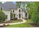 Beautiful custom home with manicured lawn and stone walkway leading to the front entrance at 960 Tiverton Ln, Alpharetta, GA 30022