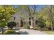 Elegant two-story home featuring a circular driveway, lush landscaping and well-maintained lawn at 960 Tiverton Ln, Alpharetta, GA 30022