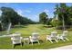 Relaxing golf course view with white Adirondack chairs and lush green fairway at 960 Tiverton Ln, Alpharetta, GA 30022