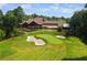 Picturesque golf course view with a clubhouse and outdoor seating on a sunny day at 960 Tiverton Ln, Alpharetta, GA 30022