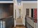 Bright hallway featuring hardwood steps, decorative walls, and white trim with recessed lighting at 960 Tiverton Ln, Alpharetta, GA 30022