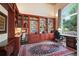 Comfortable home office with built-in bookshelves and large window at 960 Tiverton Ln, Alpharetta, GA 30022