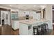 Bright kitchen with white cabinetry, stainless steel appliances, granite countertops, and a breakfast bar for casual dining at 960 Tiverton Ln, Alpharetta, GA 30022