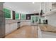 Bright, updated kitchen featuring stone countertops, tile backsplash, stainless steel appliances, and backyard views at 960 Tiverton Ln, Alpharetta, GA 30022