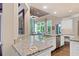 Modern kitchen with granite countertops, stainless steel appliances, and an open design flowing into the living area at 960 Tiverton Ln, Alpharetta, GA 30022