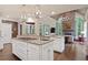 Spacious kitchen featuring granite countertops, double islands, modern appliances, and an open view to the living space at 960 Tiverton Ln, Alpharetta, GA 30022