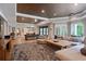 Spacious living room with a billiard table, fireplace, large sectional, and ample natural light at 960 Tiverton Ln, Alpharetta, GA 30022