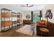 Bright living room with an area rug, hardwood floors, decorative shelves, and a window view at 960 Tiverton Ln, Alpharetta, GA 30022