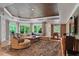 Open-concept living area with hardwood floors, large windows, and a plush sectional sofa with stylish throw pillows at 960 Tiverton Ln, Alpharetta, GA 30022