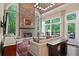 Comfortable living room with stone fireplace, large windows offering scenic views, and access to the outdoor deck at 960 Tiverton Ln, Alpharetta, GA 30022