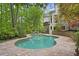 Inviting backyard pool surrounded by stone and a lush wooded area at 960 Tiverton Ln, Alpharetta, GA 30022