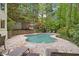 Inviting backyard pool surrounded by stone patio, lush landscaping, and mature trees for privacy at 960 Tiverton Ln, Alpharetta, GA 30022