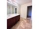 Bathroom featuring a double vanity with dark wood cabinets and tiled flooring at 2089 Belmont Cir, Conyers, GA 30012