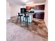 Kitchen with dark wood cabinets, island with bar seating and appliances at 2089 Belmont Cir, Conyers, GA 30012