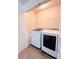 Functional laundry room includes a washer, a dryer, and wire shelving for storage at 2089 Belmont Cir, Conyers, GA 30012