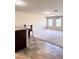 Open-concept living area featuring carpet, adjacent bar seating, and natural light through multiple windows at 2089 Belmont Cir, Conyers, GA 30012