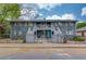 Charming apartment building with inviting turquoise doors, fenced front yard, and beautiful landscaping at 210 Sampson Ne St # 8, Atlanta, GA 30312