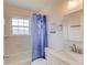 Bright bathroom with a shower-tub, white vanity, and a window allowing natural light at 210 Sampson Ne St # 8, Atlanta, GA 30312
