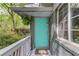 Charming turquoise front door with white railing and lush greenery at 210 Sampson Ne St # 8, Atlanta, GA 30312