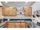 Bright kitchen with wood cabinets, granite countertops, and ample storage, ideal for cooking enthusiasts at 210 Sampson Ne St # 8, Atlanta, GA 30312